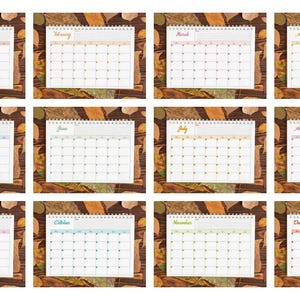May include: A collection of twelve monthly calendars, each with a different color scheme for the month's name. The calendars are set against a backdrop of autumn leaves and a wooden surface.