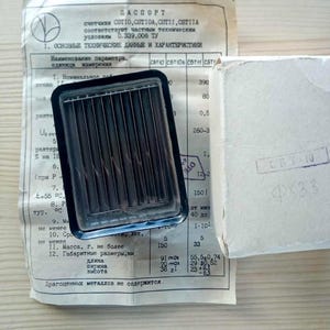 May include: A vintage electronic component with a black rectangular frame and parallel metal rods, next to a document with Cyrillic text and a small white box. The document includes technical specifications and measurements. The component's dimensions are approximately 3.58 inches long, 2.75 inches wide, and 0.9 inches high.