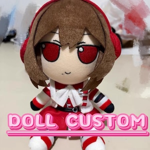 May include: A plush doll with brown hair, red eyes, and a red headband. The doll wears a red and white outfit with a white bow at the neck and black accents. The text DOLL CUSTOM is printed in pink letters across the bottom of the image.