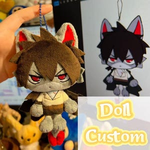 May include: A plush doll featuring a grey wolf-like character with brown hair, red eyes, and pointed ears with red inner details. The doll wears a cream-colored shirt and dark brown pants, attached to a blue ball chain for hanging as a charm.
