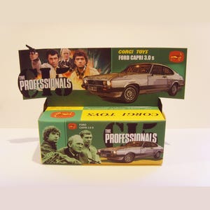 May include: A green and yellow box featuring a silver Ford Capri 3.0S car and the text "The Professionals" on the front. The box is a Corgi Toys model car.