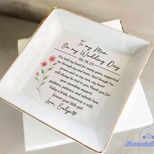 May include: White ceramic trinket dish with gold trim, featuring a heartfelt message to a mother on her wedding day. The dish includes a floral design and the text "To my Mom, On my Wedding Day".