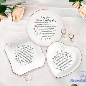 May include: Three white ceramic ring dishes with gold trim, each featuring a heartfelt message and floral accents. One is round, one square, and one heart-shaped, perfect for wedding gifts.