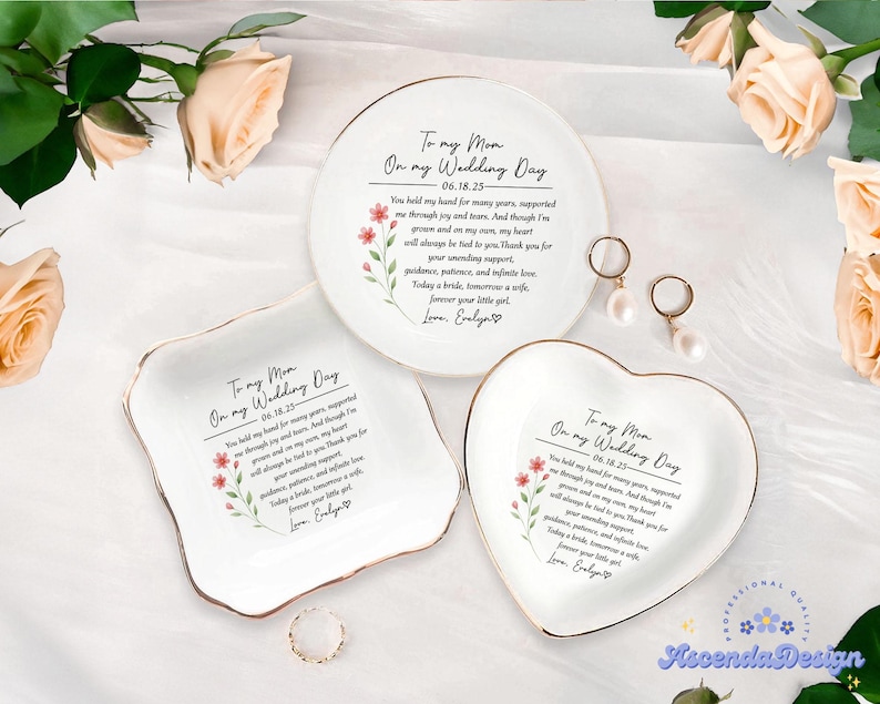 May include: Three white ceramic ring dishes with gold trim, each featuring a heartfelt message and floral accents. One is round, one square, and one heart-shaped, perfect for wedding gifts.