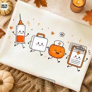 May include: A white fabric surface featuring a cartoon graphic of a syringe filled with orange liquid, a white medical kit, an orange pumpkin wearing a nurse cap, and an orange clipboard, all with smiling faces and thin black limbs.