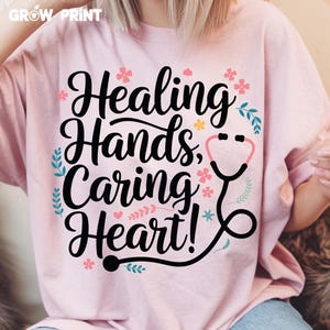 May include: Pink t-shirt with a floral design and the text "Healing Hands, Caring Heart!" with a stethoscope graphic.