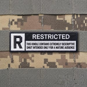 May include: A rectangular patch with the word "RESTRICTED" in white text on a black background. The patch also features a white "R" in a black square and a line of text that reads "THIS KINDLE CONTAINS EXTREMELY DESCRIPTIVE SMUT INTENDED ONLY FOR A MATURE AUDIENCE."