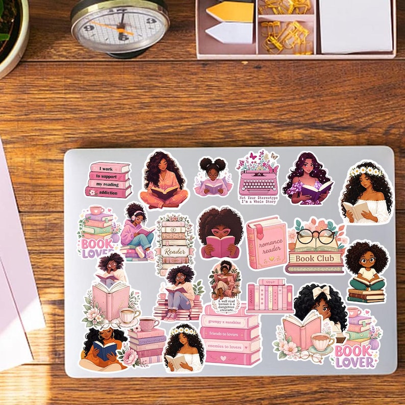 a laptop with a collection of stickers on its surface, depicting various female characters and themes related to reading and literature.