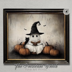 May include: A framed print featuring a whimsical Halloween scene. A ghost wearing a witch hat sits among pumpkins, reading a book, with a black cat nearby. Two bats fly above. The text "The Decadent Witch Fine Art Prints" is at the bottom.