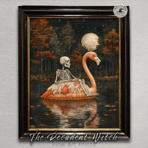 May include: Framed art print depicting a skeleton on a flamingo float in a lake under a full moon. The artwork has a dark, whimsical theme with autumn foliage and a forest backdrop. The Decadent Witch Fine Art Prints.