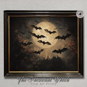 May include: Framed artwork featuring a full moon, silhouetted bats, and a gothic castle. The painting has a dark, moody color palette with the text "The Decadent Witch Fine Art Prints" at the bottom.