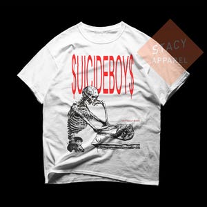 May include: White t-shirt with the red text "SUICIDEBOYS" above a black and white illustration of a skeleton in a thinking pose. The text "either hated or ignored" is below the skeleton.