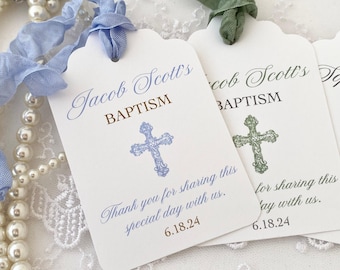May include: Three white favor tags with scalloped edges, blue and green cross designs, and the text "Jacob Scott's Baptism" and "Thank you for sharing this special day with us. 6.18.24".