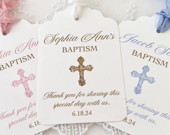 May include: Three white baptism favor tags with scalloped edges. The top tag says "Sophia Ann's Baptism" with a gold cross. The middle tag says "Jacob Scott Baptism" with a blue cross. The bottom tag says "Sophia Ann's Baptism" with a pink cross. Each tag has the text "Thank you for sharing this special day with us." and a date.