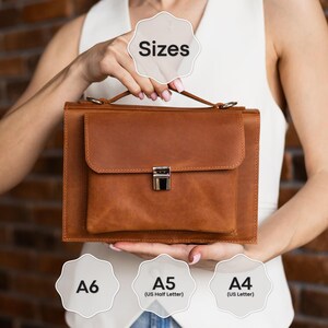 May include: A brown leather briefcase with a front pocket and a silver clasp. The briefcase has a handle and is shown with size options: A6, A5 (US Half Letter), and A4 (US Letter). The word "Sizes" is also displayed.