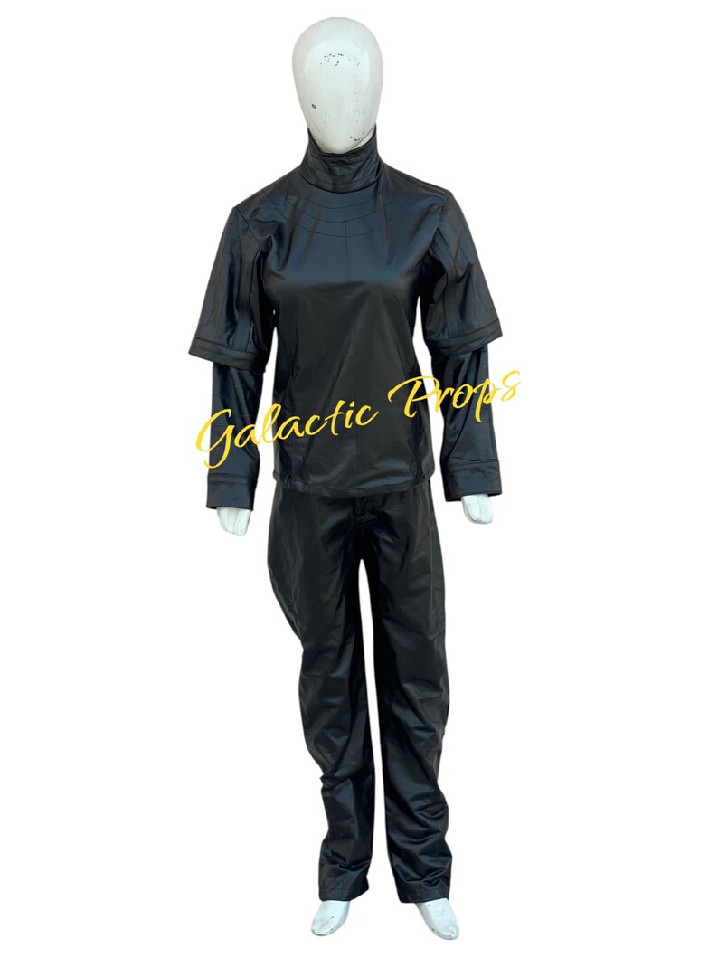 May include: A black costume displayed on a mannequin. The outfit includes a high-collared top with layered sleeves and matching pants. The text "Galactic Props" is visible in yellow script across the front of the outfit.