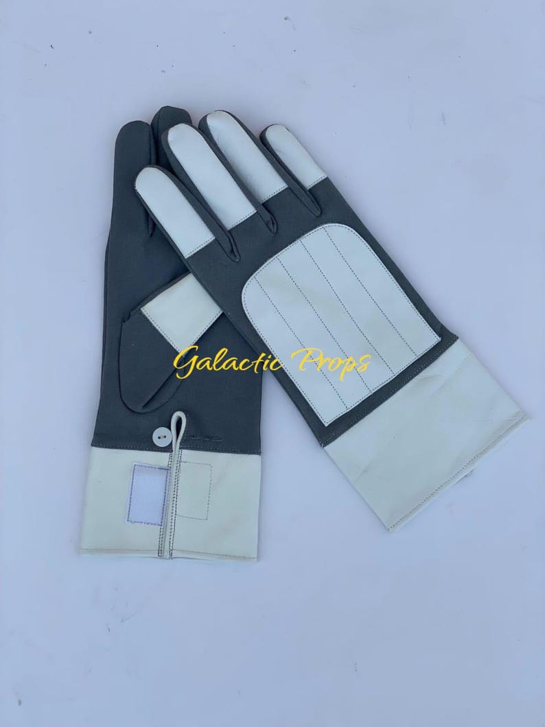 May include: A pair of gloves with a gray and white color scheme. The gloves have white fingertips and a white panel on the back of the hand. The text "Galactic Props" is visible in the image.