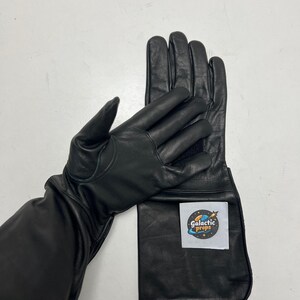 May include: Black leather gloves with long gauntlets. The gloves have a smooth texture and are designed for protection. A white label with the text "Galactic Props" is attached to the gauntlet.