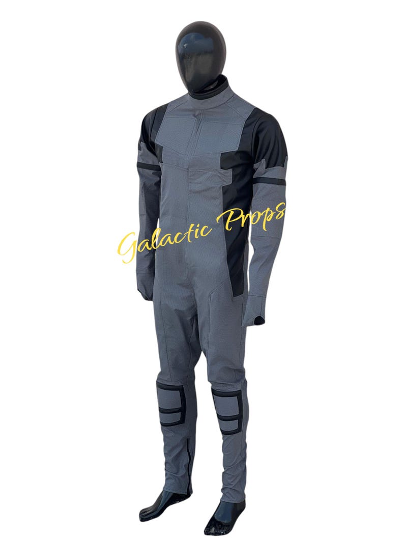 May include: A gray and black jumpsuit with a high collar, long sleeves, and knee pads. The suit is displayed on a mannequin. The text "Galactic Props" is visible in the image.