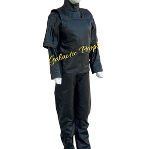 May include: A black costume displayed on a mannequin. The outfit includes a high-collared jacket with shoulder accents and long sleeves, paired with matching black pants. The text "Galactic Props" is visible on the jacket.