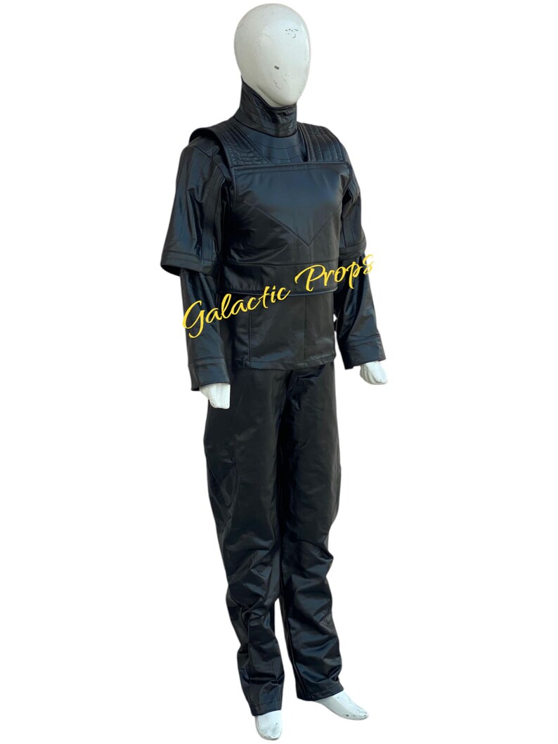 May include: A black costume displayed on a mannequin. The outfit includes a high-collared jacket with shoulder accents and long sleeves, paired with matching black pants. The text "Galactic Props" is visible on the jacket.