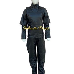 May include: Black costume set on a mannequin. The set includes a high-collared jacket with shoulder accents, long sleeves, and matching pants. The text "Galactic Props" is visible on the jacket.