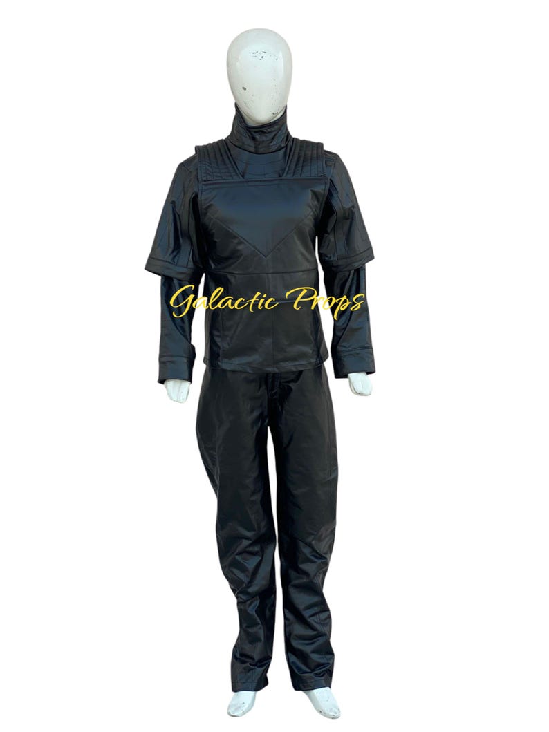 May include: Black costume set on a mannequin. The set includes a high-collared jacket with shoulder accents, long sleeves, and matching pants. The text "Galactic Props" is visible on the jacket.
