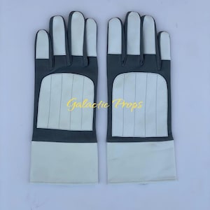 May include: A pair of gray and white gloves with a rectangular design on the back of the hand. The gloves have a white palm and fingers, with the text "Galactic Props" in gold lettering.