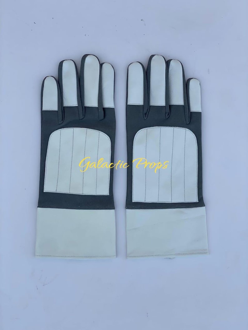 May include: A pair of gray and white gloves with a rectangular design on the back of the hand. The gloves have a white palm and fingers, with the text "Galactic Props" in gold lettering.