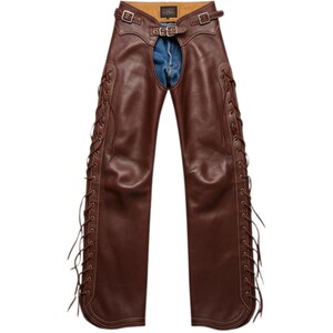 May include: Brown leather chaps with adjustable buckle fastenings at the waist and upper thighs. The chaps have decorative lacing along the outer seams and are designed to be worn over jeans.