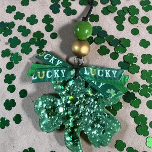 May include: A trio of ceramic mugs with a speckled, matte finish in cream, light grey, and dark grey. Each mug features a minimalist design and a rounded handle.