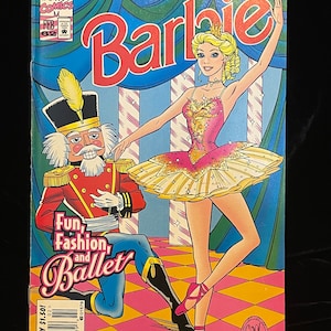 May include: A comic book cover featuring Barbie dressed as a ballerina with a Nutcracker doll. The cover is pink, yellow, and blue with the title "Barbie" in large red letters. The text "Fun, Fashion, and Ballet" is written in a white box on the cover.