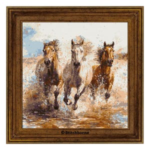 May include: A framed cross-stitch artwork showing three horses galloping through water. The horses are various shades of brown and white, with water splashing around their hooves. The artwork is in a brown wooden frame. The text "© Stitchborne" is in the bottom center.