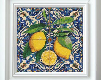 May include: Framed art print depicting lemons with green leaves against a blue and white patterned backdrop. The lemons are yellow. The artwork is presented in a white frame.