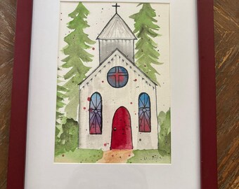Puede incluir: Pintura a la acuarela de una iglesia blanca con una puerta roja y vidrieras, enmarcada en un marco burdeos. Dos árboles verdes flanquean la iglesia. La obra está firmada "Michelle".
