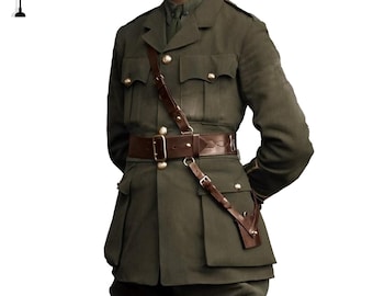 May include: A vintage olive green military uniform. The jacket has four front pockets, gold buttons, and a brown leather belt and shoulder strap. The uniform is a historical garment.