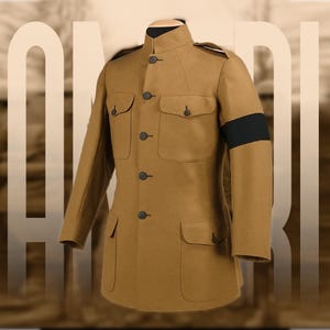 May include: A tan military-style jacket with a high collar, four front pockets, and black buttons. A black armband is on the left sleeve. The jacket is displayed on a mannequin.