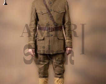 May include: A military uniform in olive drab, featuring a high-collared jacket with four pockets, matching trousers, and a brown leather belt and shoulder strap. The outfit includes a helmet and tall, tan boots. The uniform is reminiscent of historical military attire.