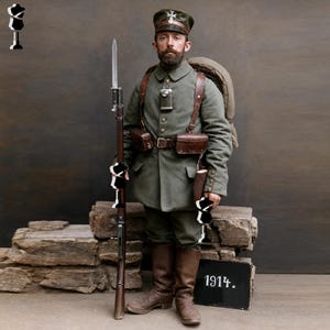 May include: A soldier in a grey wool uniform with a matching cap, brown leather boots, and gear, holding a long rifle with a bayonet. The soldier wears a backpack, a metal canteen, and pouches. A black sign with the white text 1914 is visible.