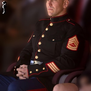 May include: A black military uniform with gold buttons and red trim. The uniform has a high collar, shoulder patches, and sleeve stripes. The person is seated, with hands clasped, wearing a blue belt and blue trousers.