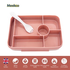 May include: A pink divided lunch tray with a white fork-spoon utensil. The tray has multiple compartments and a circular cup holder. The image also shows icons indicating the product is BPA-free, leak-proof, dishwasher and microwave safe, heat resistant, and includes cutlery.