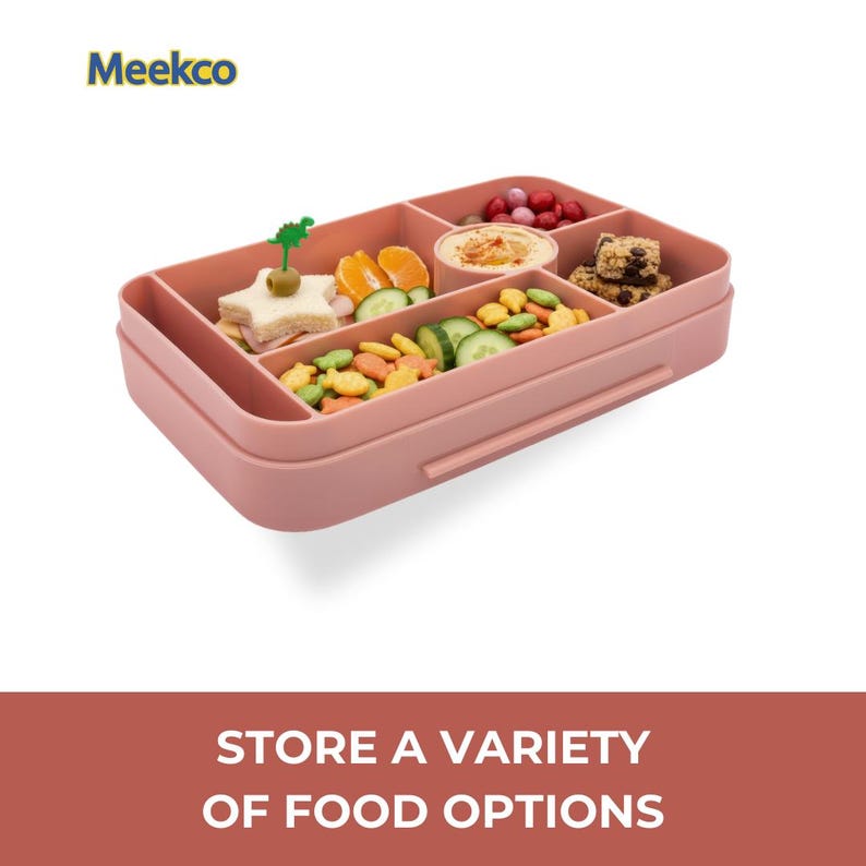 May include: A pink rectangular lunch box with multiple compartments filled with various foods, including sandwiches, fruits, vegetables, and snacks. The lunch box has a handle and the text "Meekco" is visible.