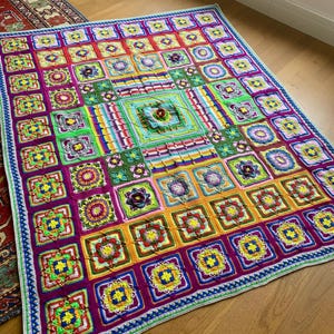 May include: A large, colorful crochet blanket with a square pattern. The blanket features a variety of vibrant colors, including pink, green, yellow, and blue. The design includes floral and geometric motifs, with a detailed border.