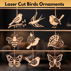 May include: Laser cut wooden bird ornaments in various designs, including a bird on a branch, a swallow, and a bird with a sunflower. The ornaments are suspended by twine and are suitable for home decor.