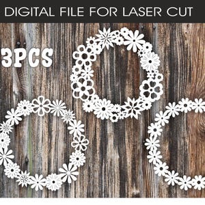May include: Three white floral wreath designs for laser cutting, featuring different flower styles. The image includes the text "DIGITAL FILE FOR LASER CUT" and file type abbreviations. The wreaths are displayed on a rustic wooden background.