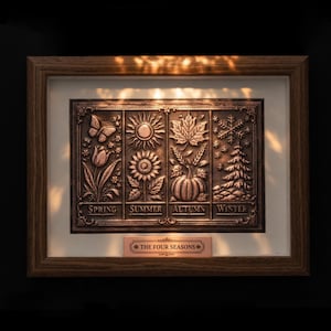 May include: A framed bronze relief sculpture depicting the four seasons. The artwork features detailed images of a butterfly, sun, leaf, and snowflake, with corresponding text labels. The frame is made of wood, and a small plaque at the bottom reads "The Four Seasons."