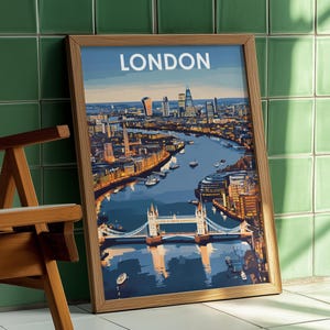 May include: Framed art print featuring a detailed illustration of London's skyline, including the Tower Bridge and the River Thames. The word "LONDON" is printed at the top. The artwork is in a wooden frame and leans against a green tiled wall.