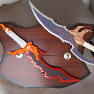 May include: Two decorative fantasy swords mounted on a wooden plaque. One sword has a purple blade with gold accents and a white handle. The other has an orange blade with a red outline and a white handle. The plaque is brown.
