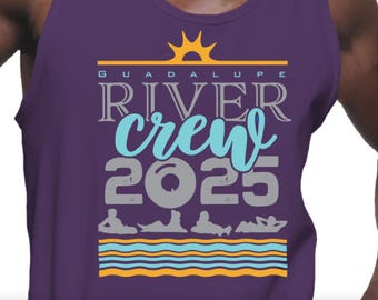 May include: Purple tank top with the text "GUADALUPE RIVER CREW 2025" in white, gray, and teal. The design includes a sun graphic and illustrations of people relaxing on the water. A yellow and orange striped design is at the bottom.