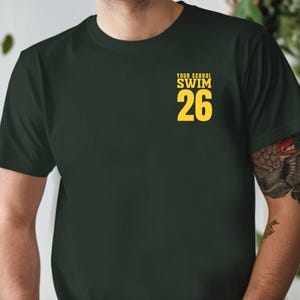 Example of Design on front of tee, yellow text on Forest. Add custom school or mascot name on top line.